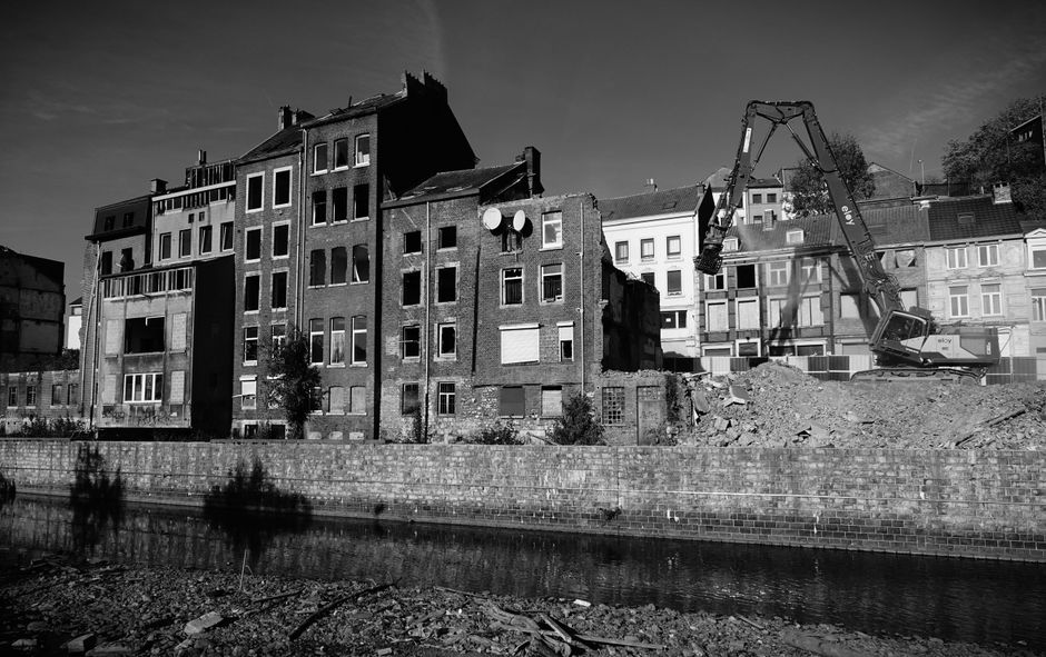 Heavy machinery and rubble at a demolition site.