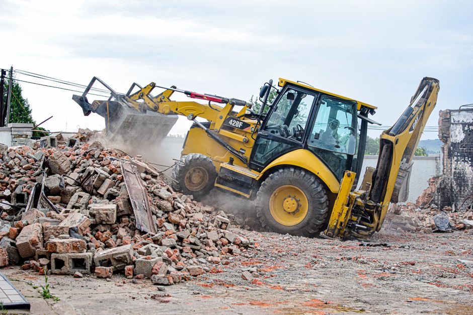 Heavy machinery and rubble at a demolition site.