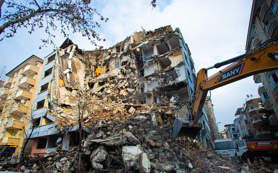 An excavator at work on a demolition site.