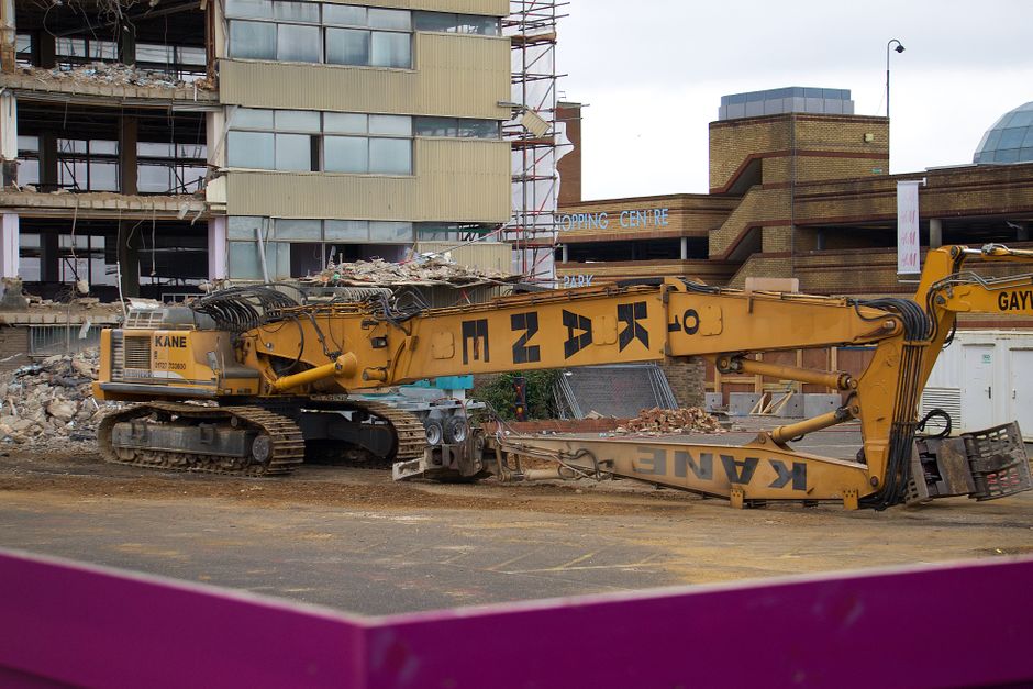 An excavator at work on a demolition site.