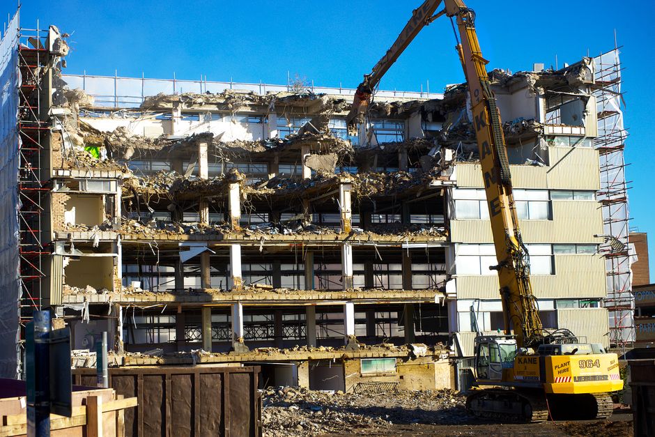 An excavator at work on a demolition site.